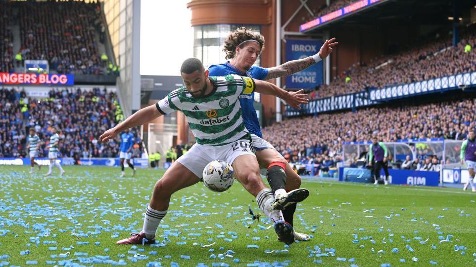 Two players fight for the football