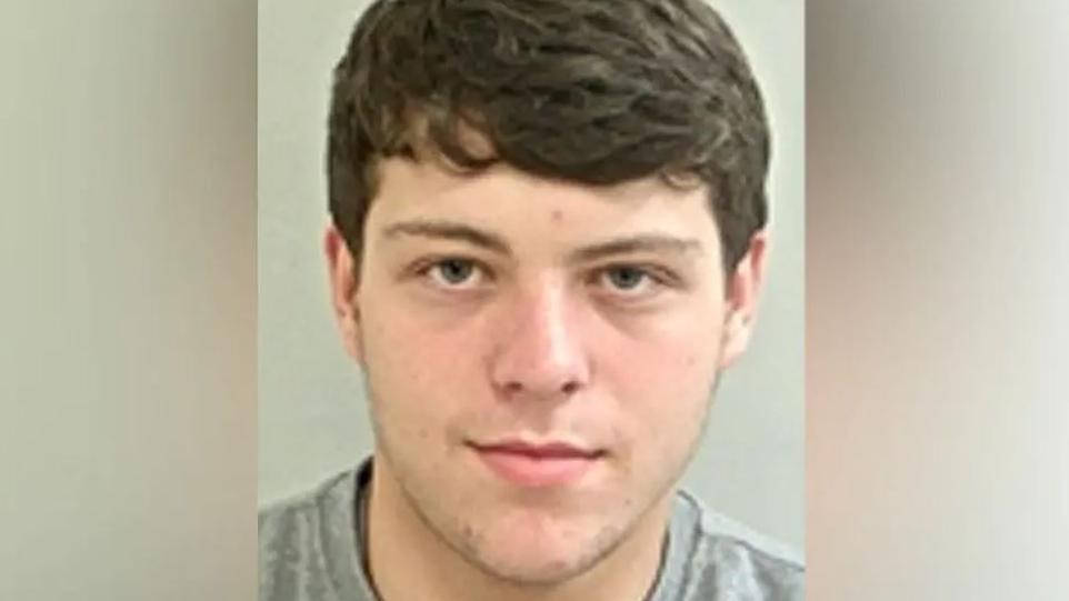 Custody image of Henry Houghton with brown hair and wearing a grey t-shirt.