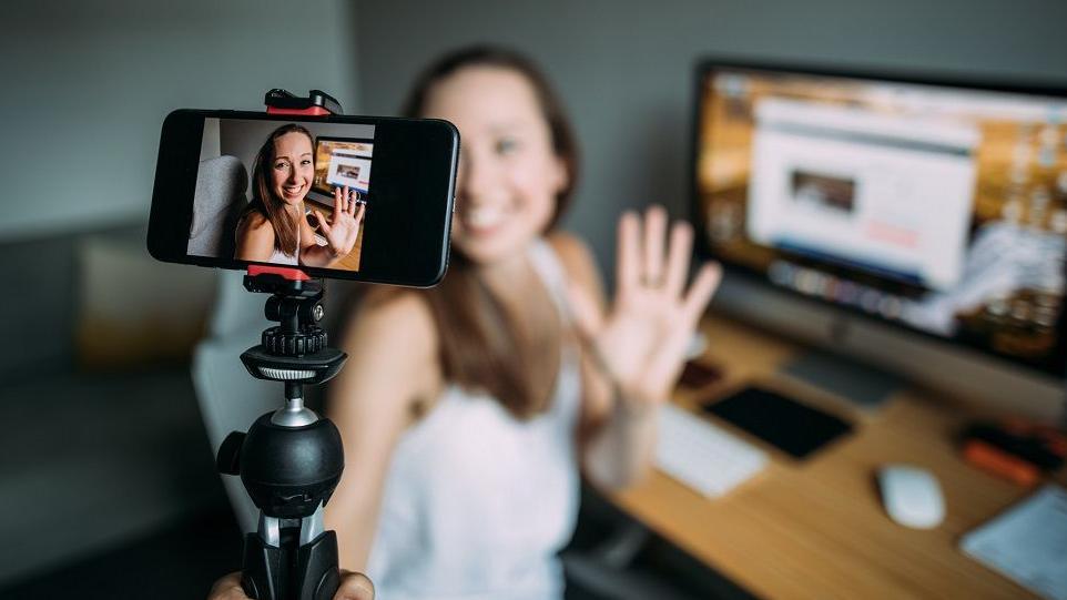 Woman with webcam and computer