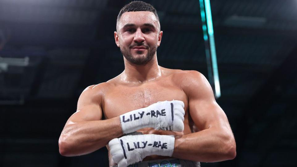Callum Simpson shows his sister's name on his handwraps following a win