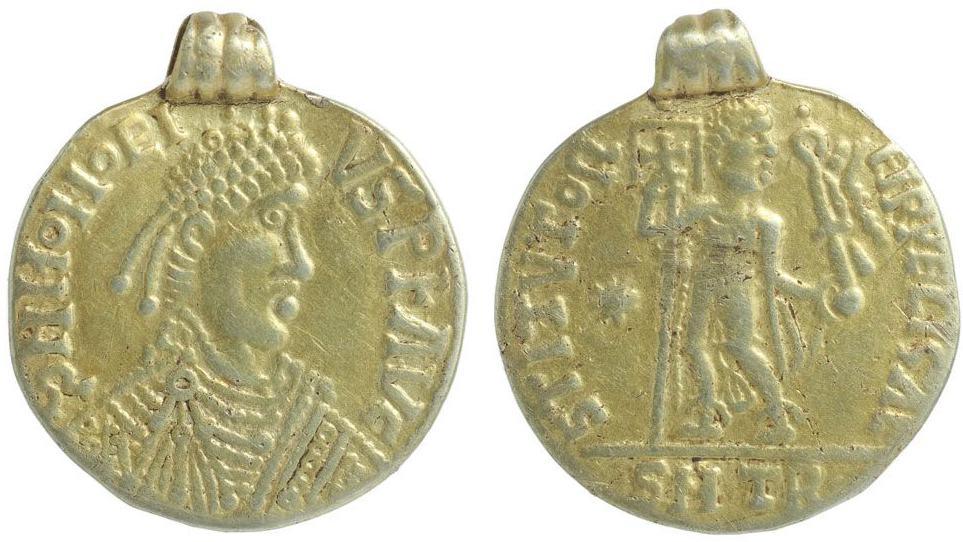 Gold Anglo-Saxon Roman-style pendant, showing a fairly crude image of an Emperor with writing around it on the front and a back view of a figure holding a banner, also with writing around it