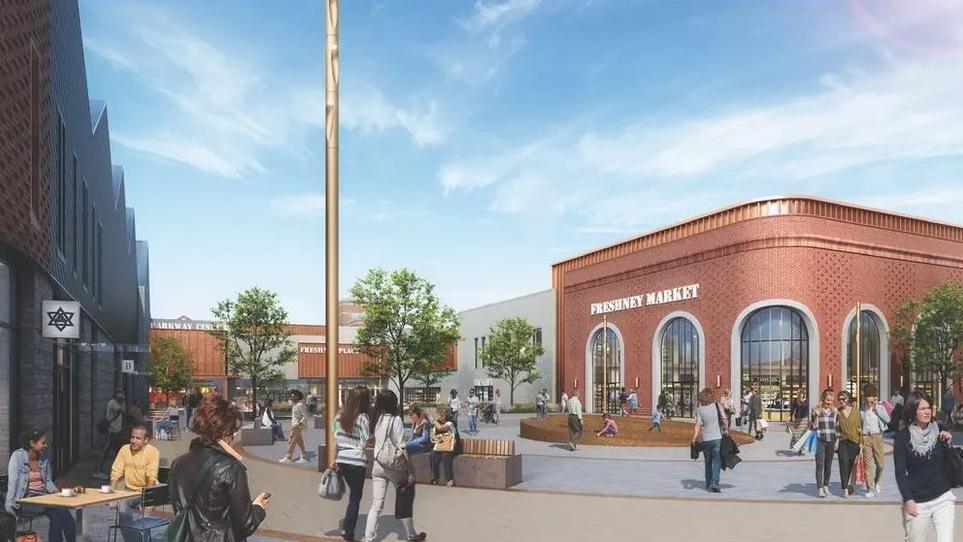 A CGI image of people walking across a modern-looking market square. On the left is a one-storey red brick corner building with large floor-to-ceiling art-deco shaped windows and a 'Freshney Market' sign on the left-hand side of the building. On the right are people sitting at a table with tea cups outside a coffee shop.