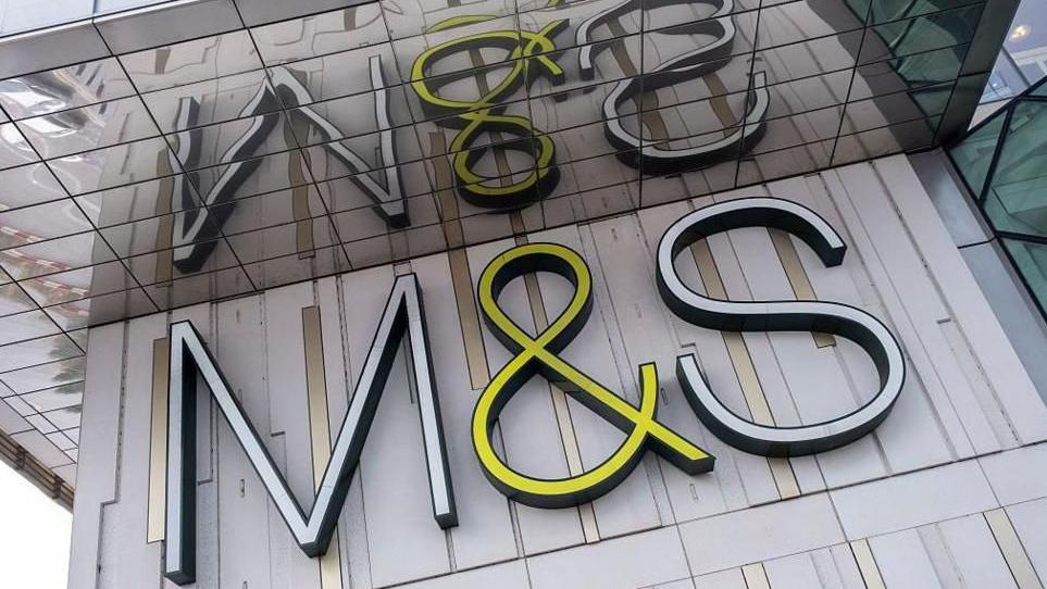 M&S sign on a grey wall