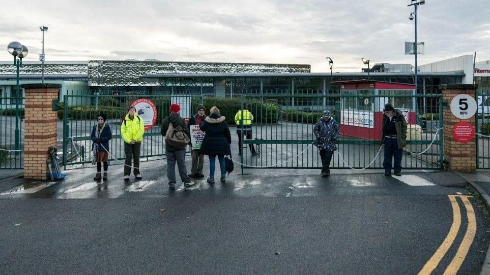 protesters chained across a gateway