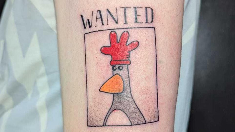 tattoo of Feathers McGraw wearing his red rubber glove hat.