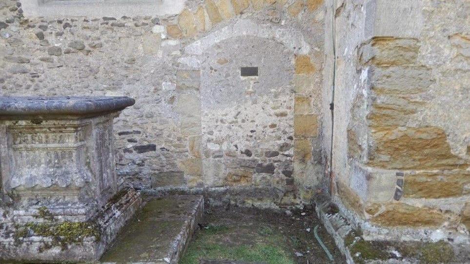 The outline of a small cell is visible on a church wall