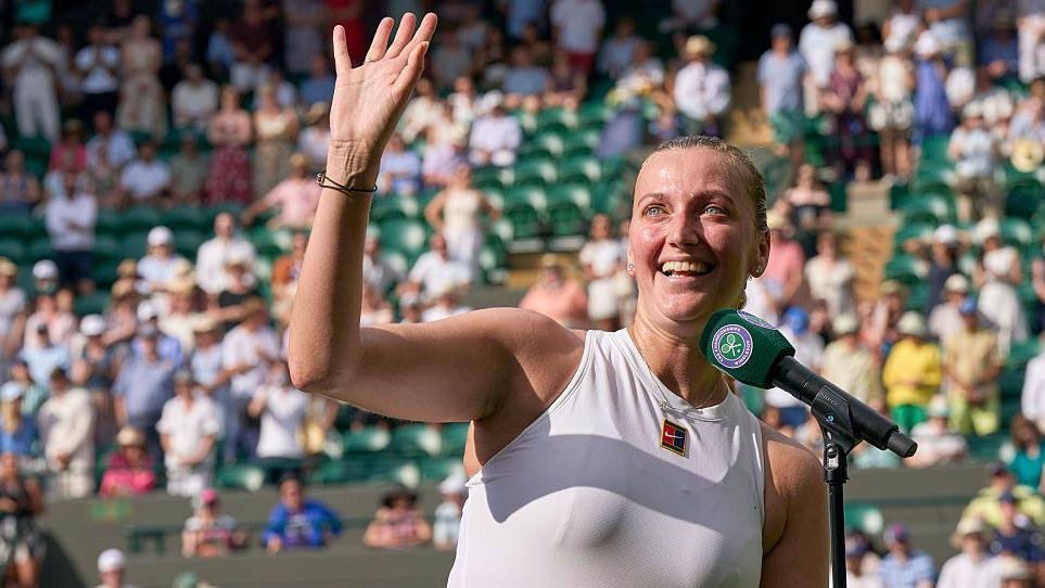 Petra Kvitova waves while giving her on-court speech