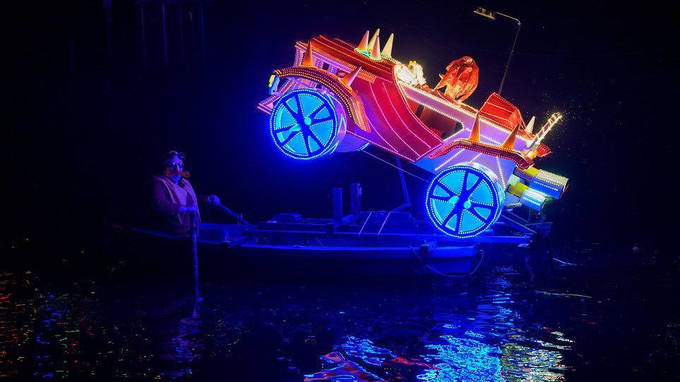 A man dressed as Doctor Eggman riding a boat with an LED sculpture of Knuckles the Hedgehog