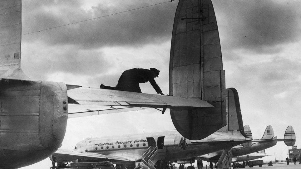 A scene at London Airport, Heathrow, one of the world's busiest airports. In the foreground a York bound for South Africa, and behind it American airliners being refuelled for their return journey to the United States, 1946