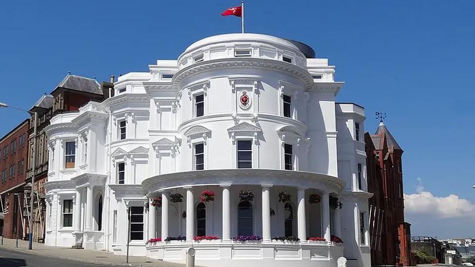 The Isle of Man's parliamentary building, known as the Wedding Cake, which is a round, white, three-tiered building.