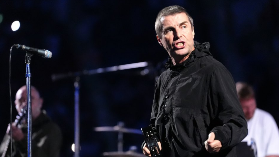 Liam Gallagher, dressed in a black coat and holding a tambourine, plays at a gig ahead of an IBF heavyweight bout between Anthony Joshua and Daniel Dubois at Wembley in September 2024