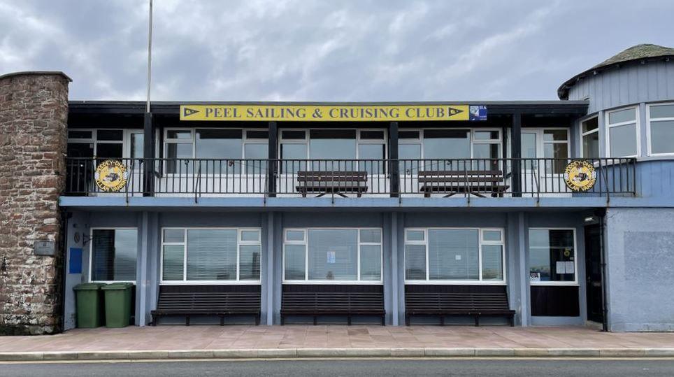 Blue building with a sign saying Peel Sailing and Cruising Club