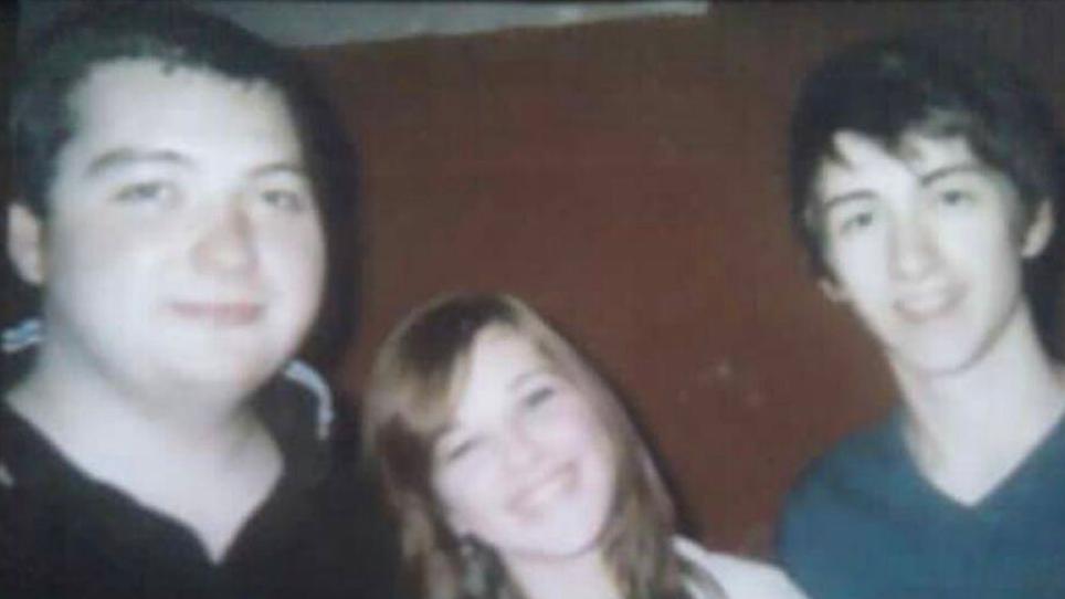 An old picture of two members of the Arctic Monkeys and the teenage girl who was on their debut single album cover