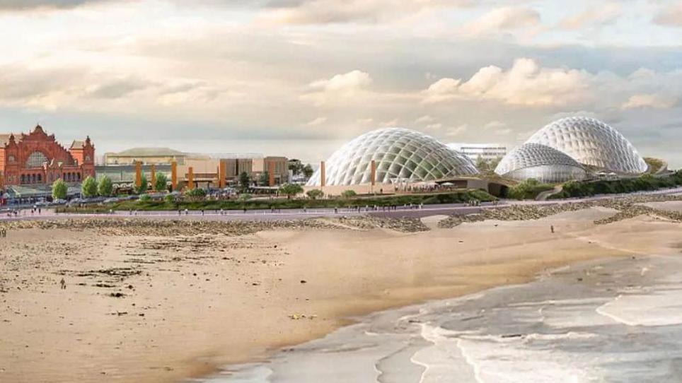 Artist impression of the Eden Project in Morecambe, showing the beach and sea overlooked by three large glass-domed pavilions shaped like shells