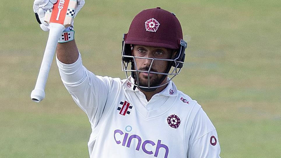 Saif Zaib raises his bat to the crowd