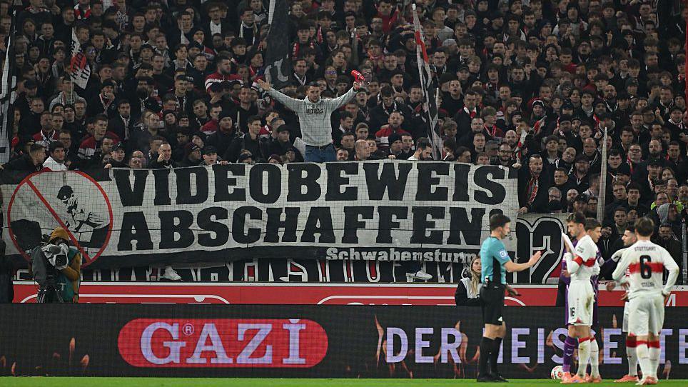 Supporters of VfB Stuttgart hold up a sign calling for the abolishment of the VAR