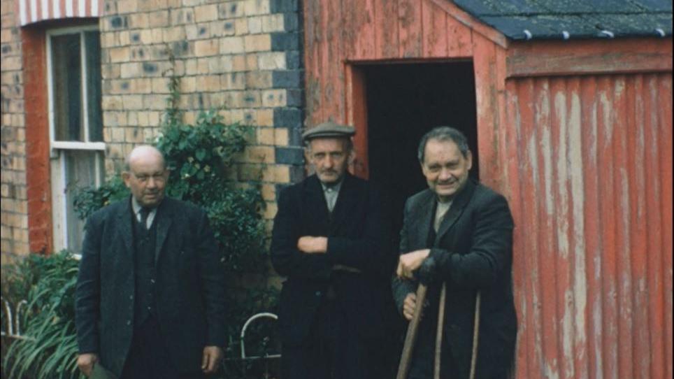 John (left) and Jim James (right) wearing black looking at the camera