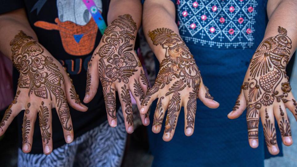 Girls showing off their henna