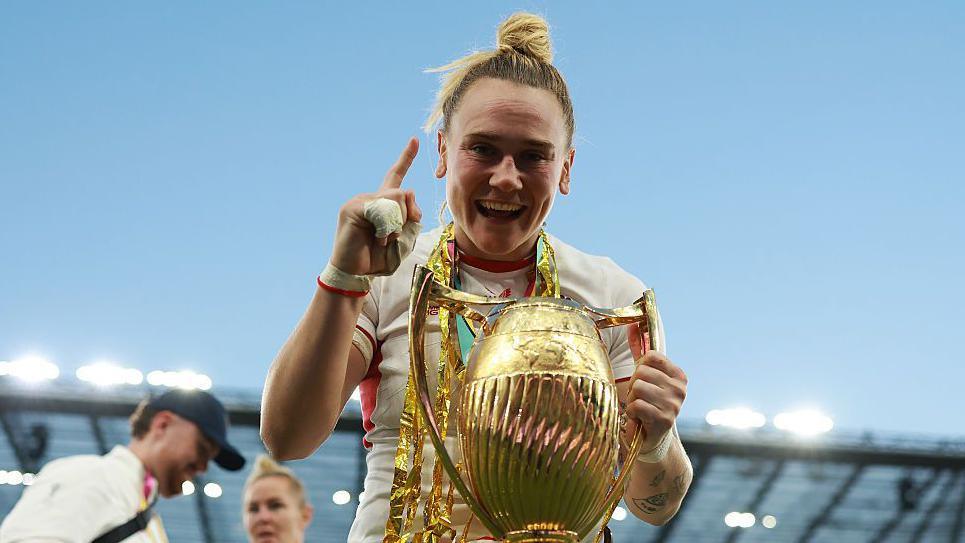 Meg Jones holding the World Cup after England's win in the final