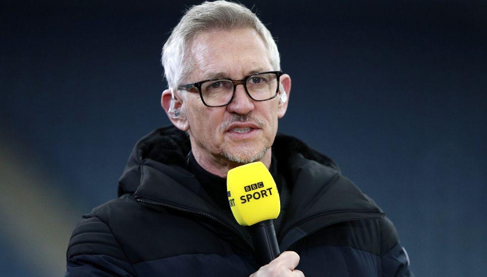 Gary Lineker pictured on a football pitch in 2021 holding a BBC Sport microphone