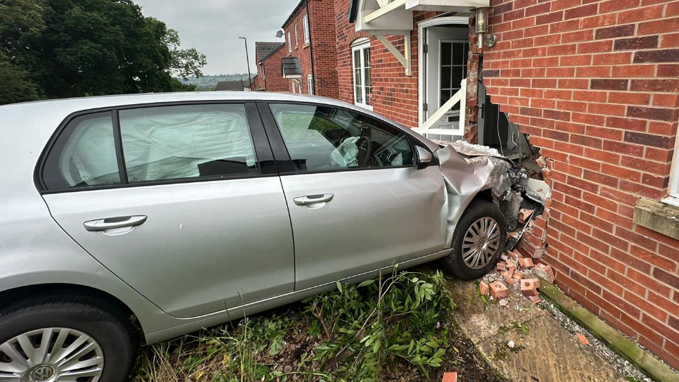 The car was left embedded in the front of the house