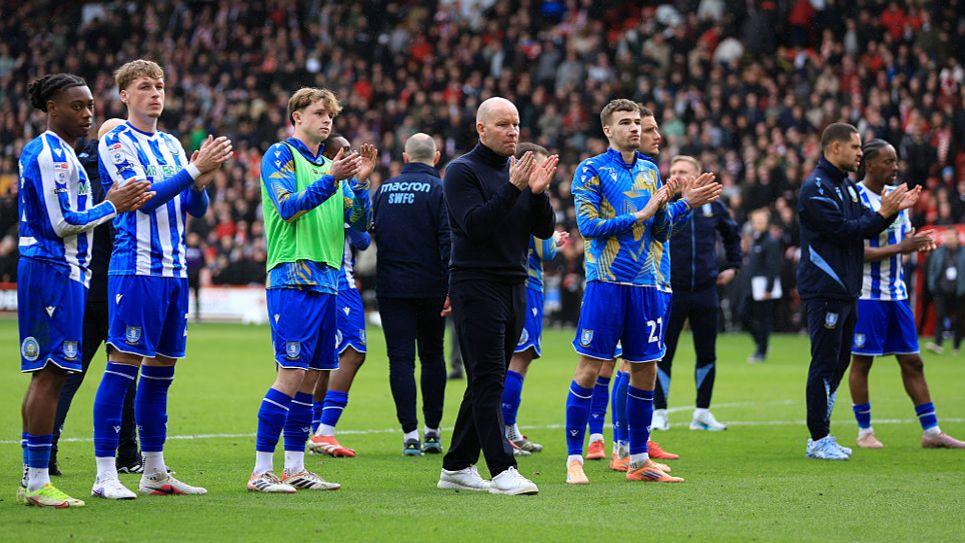 Sheffield Wednesday boss Henrik Pedersen (centre and his player) applaud the club's travelling support at Bramall Lane 