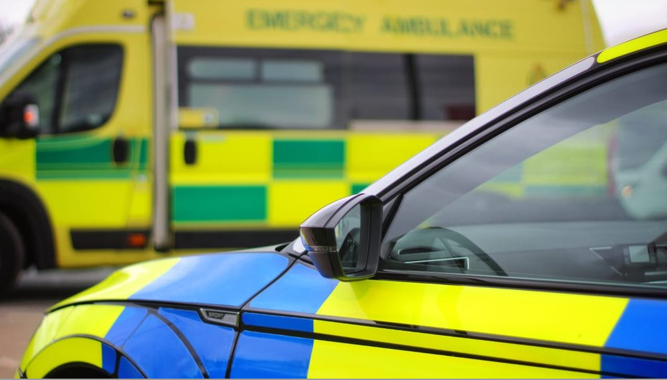 A police car parked in front of an ambulance