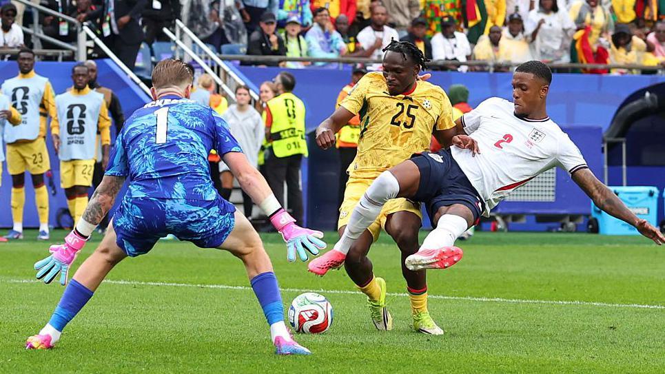 Ezri Konsa of England makes a challenge on Prince Kwabena Adu of Ghana during the FIFA World Cup 2026 Group L match