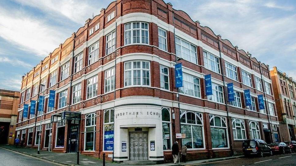 The former Northern Echo building in Darlington, an Edwardian brick building on the junction of two streets, with the words Northern Echo above the door. 