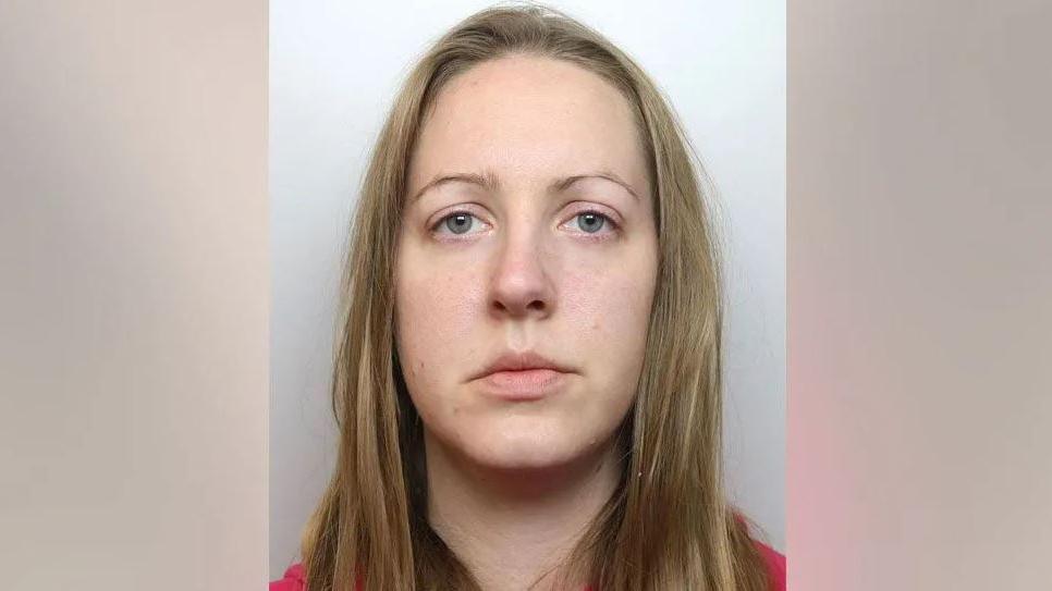 A police mugshot of Lucy Letby, who has straight blonde hair and stares into the camera with a blank expression