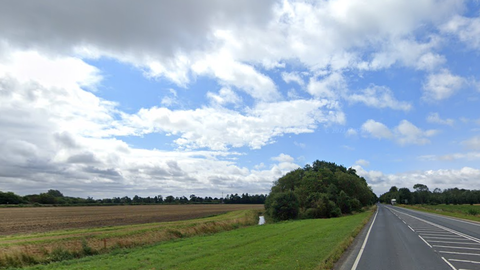 Flat agricultural fields seen from an A-road