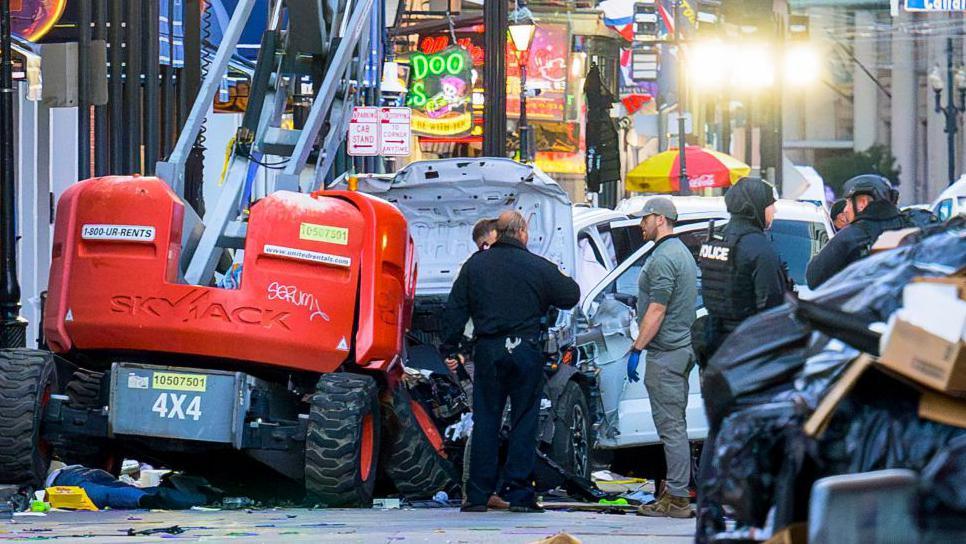 The wrecked white pickup truck surrounded by police on Wednesday morning