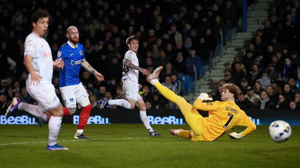 Ethan Galbraith of Swansea City misses a chance as Nicolas Schmid of Portsmouth attempts to make the save 