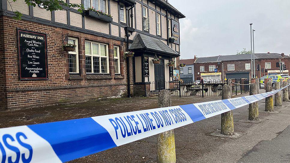 Police tape cordoning off the Fairway Inn pub in New Moston.