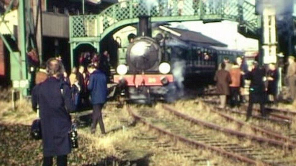 The last train from Newport on 24 January 1971, with people seen milling around the train tracks as a steam train appears to be passing through under a bridge