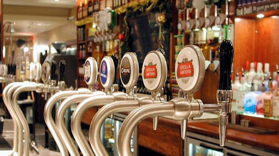 Generic image of a bar in a pub showing beer pumps  with bottles of spirits in the background