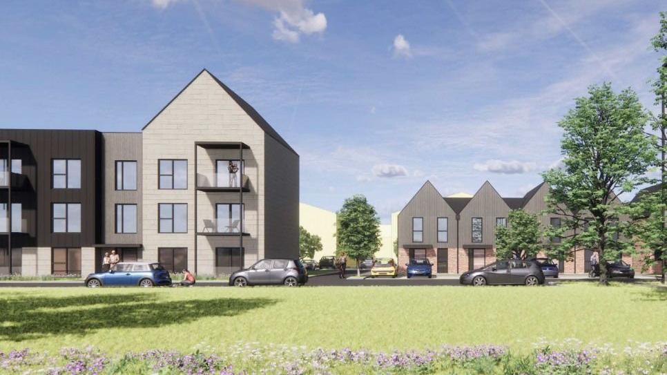 A mock up of a planned housing development showing two storey homes in a grey brick with a grassy meadow in front.