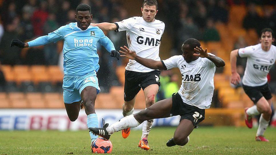 Anthony Griffith slides in for a tackle during a game for Port Vale