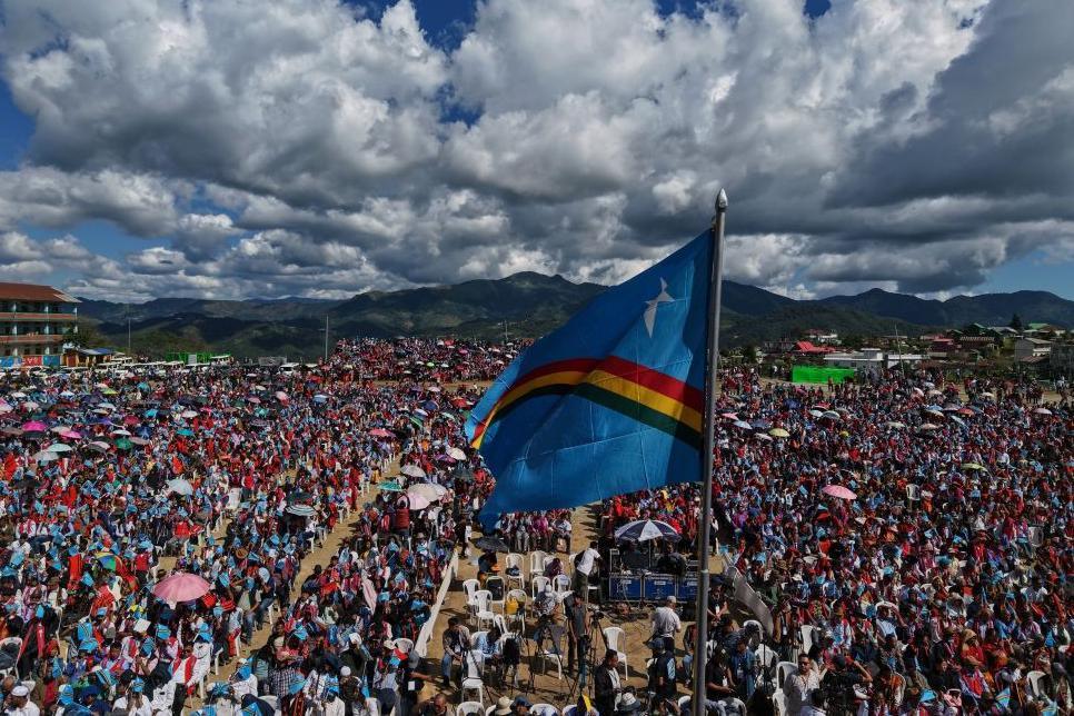 People waving the Naga flag wait for the arrival of Muivah last week