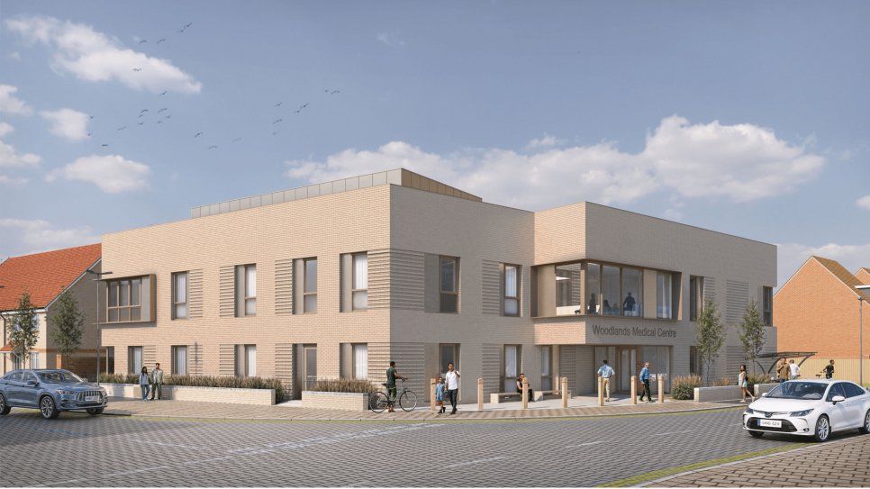 An artist's impression shows what the new GP surgery will look like. It is on the corner of two roads, and is a beige building with large windows. It says "Woodlands Medical Centre" on one side. 