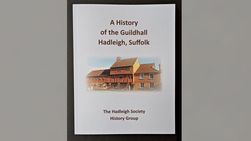 A picture of the front of the new Hadleigh Guildhall history book. The book front is white with a picture of the building and the book's title.