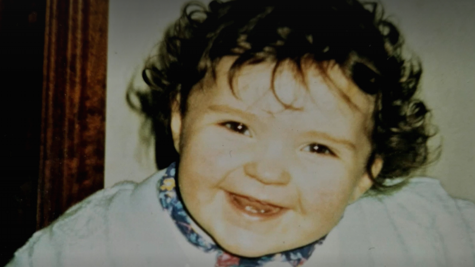 A young child smiling at the camera