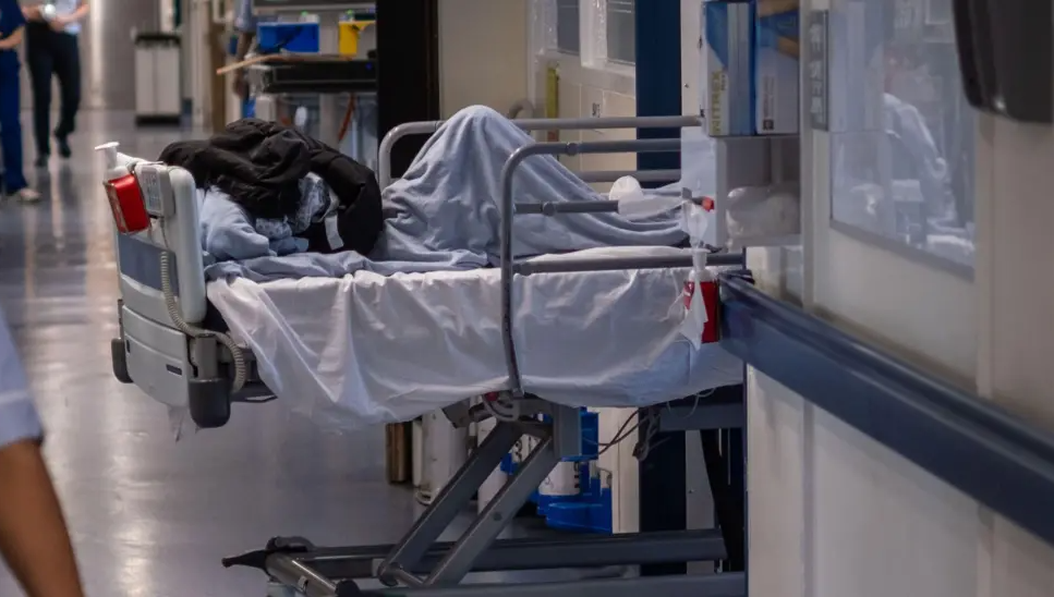 stock image shows a patient in a hospital bed waiting on a ward