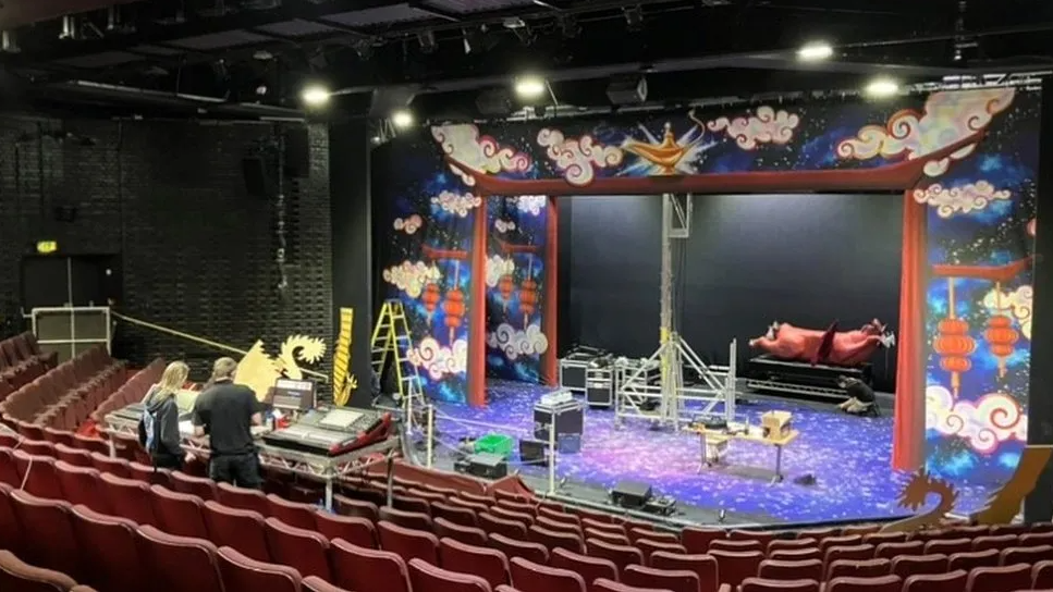 The Key Theatre's empty auditorium with rows of red seats and a stage.