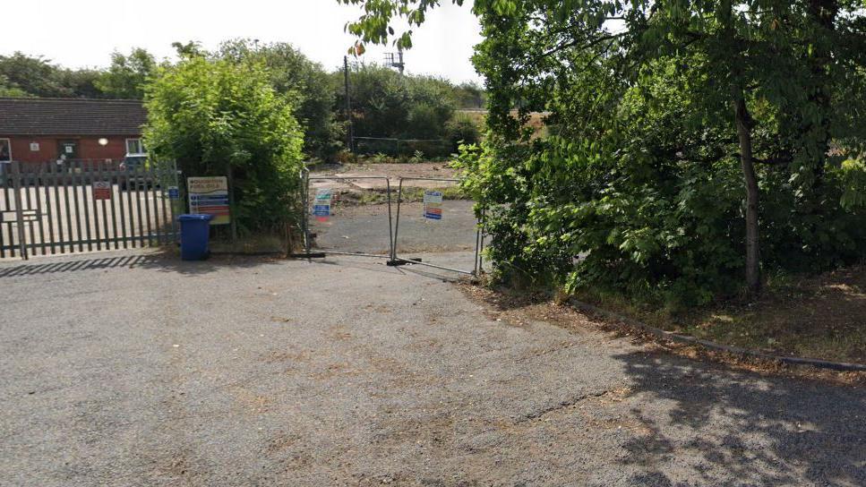 Derelict site of former British Legion club, the building has been knocked down and the site is fenced off with  health & safety notices on the fence. 