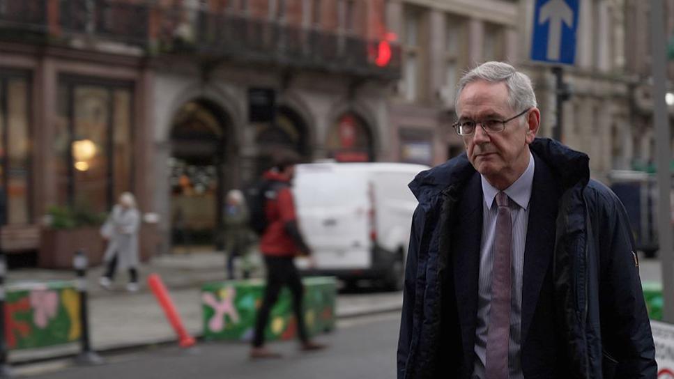 Dr John Gibbs arriving to give evidence at Thirlwall Inquiry at Liverpool Town Hall