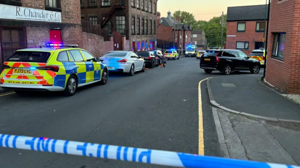 Multiple police cars behind a police corodon