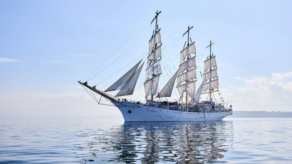 The ship at full mast at sea.