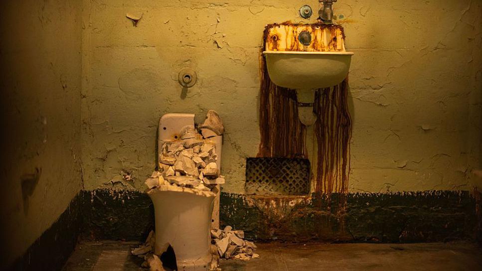 A cell at Alcatraz Island shows a broken toilet and sink