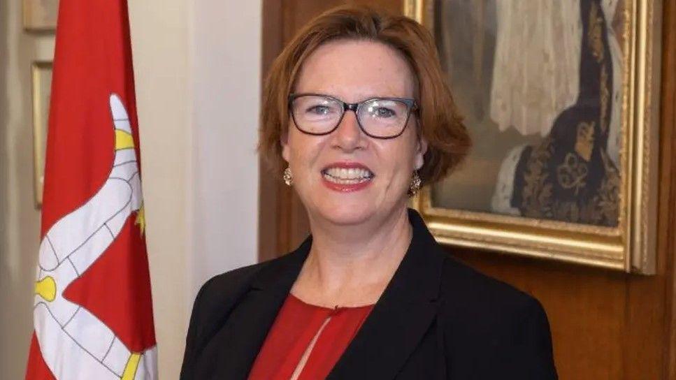 Jane Poole-Wilson, who has brown hair in a short bob and is wearing glases.